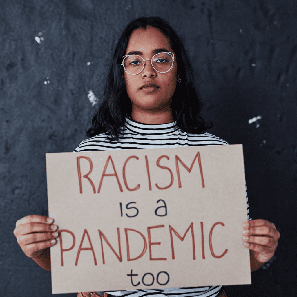 Black girl holding racism is a pandemic sign